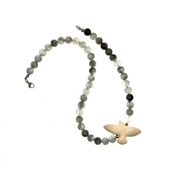 A smoky quartz necklace with a ceramic dove bird