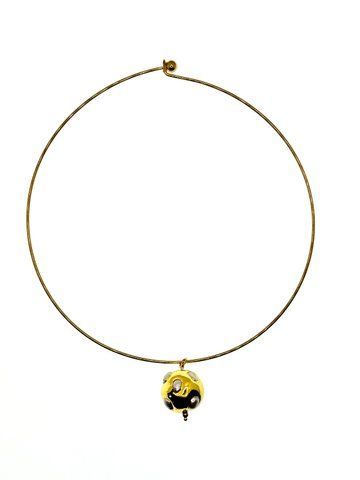 A ball pendant on a metal string with mother-of-pearl inserts