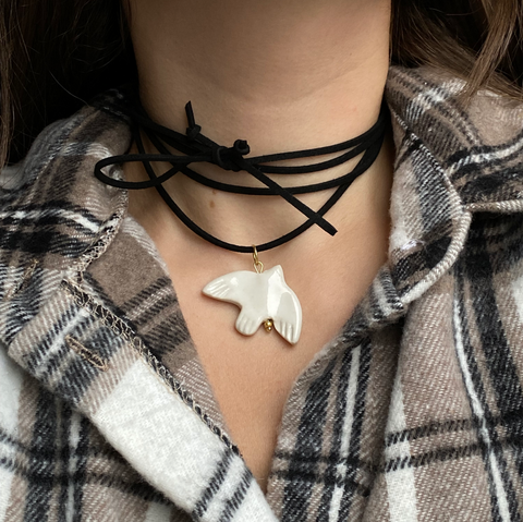 Ceramic ethnic bird on a suede cord